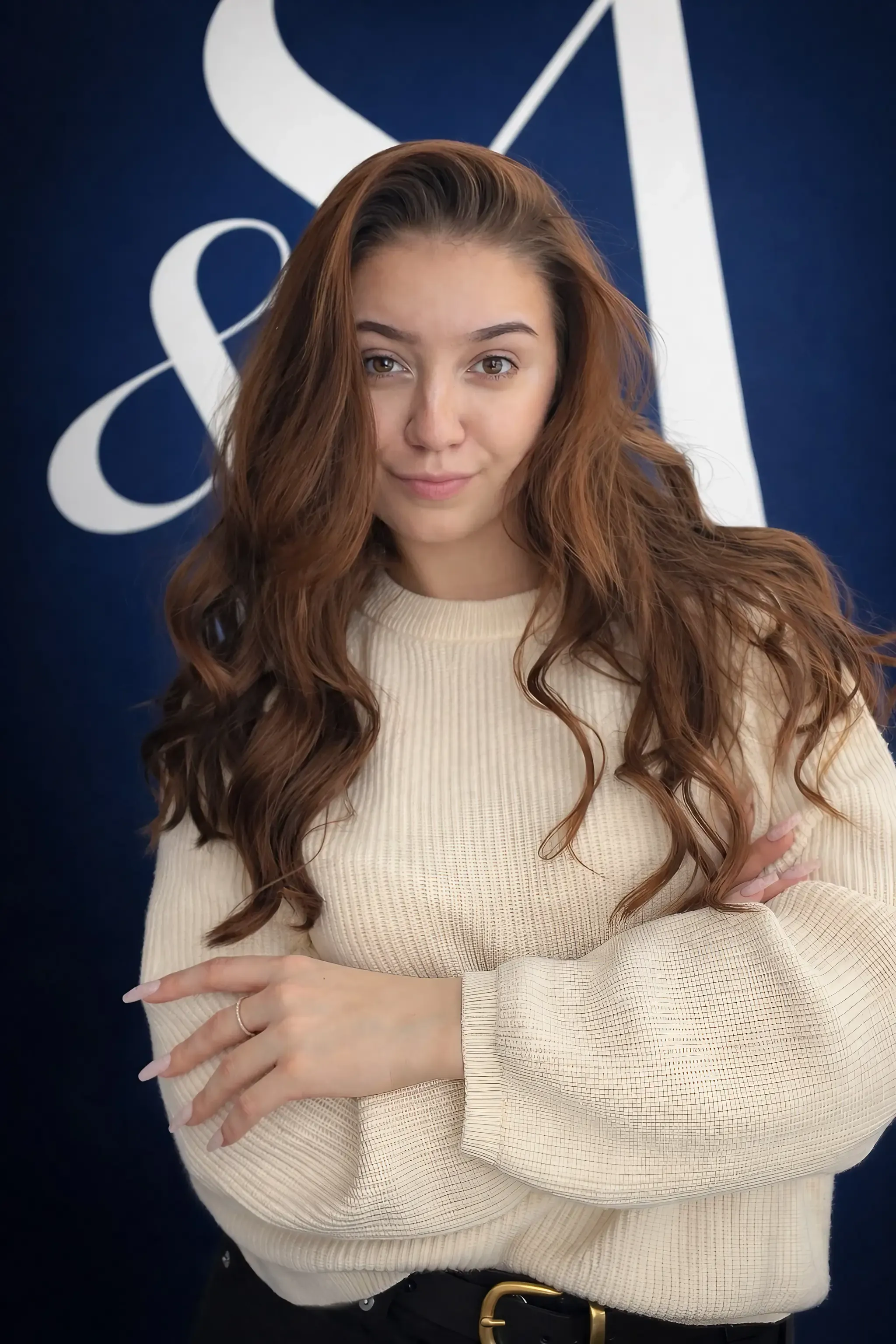 professional and friendly female nail artist in a clean modern salon setting with a warm smile